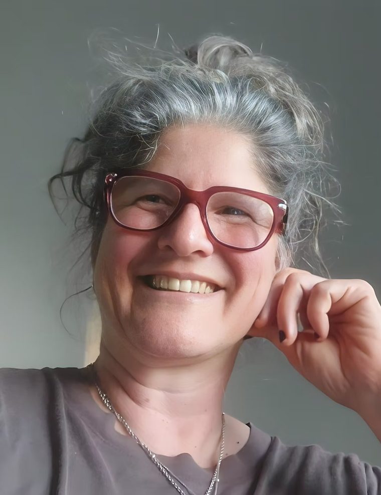 Sofia Woloschin, founder of Metanoia, smiling in a softly lit portrait
